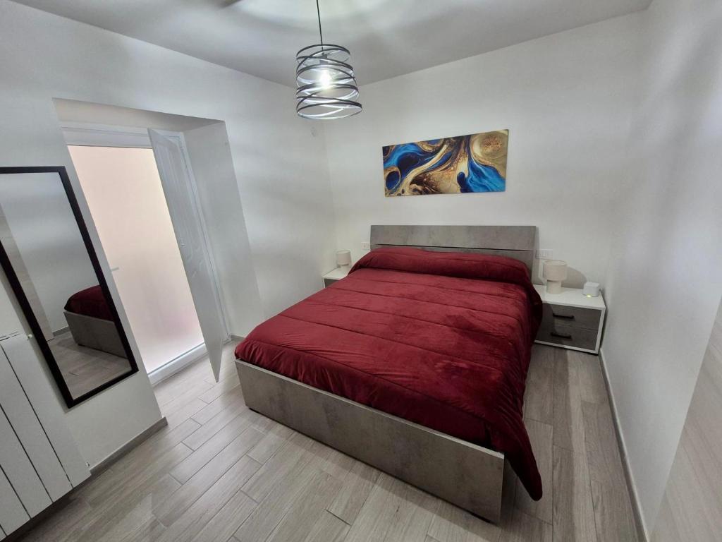 a bedroom with a bed with a red bedspread at Residenza Aurora in Isernia