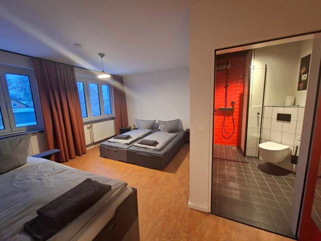 a bedroom with a bed and a couch and a bathroom at KulturHaus Locktow in Locktow