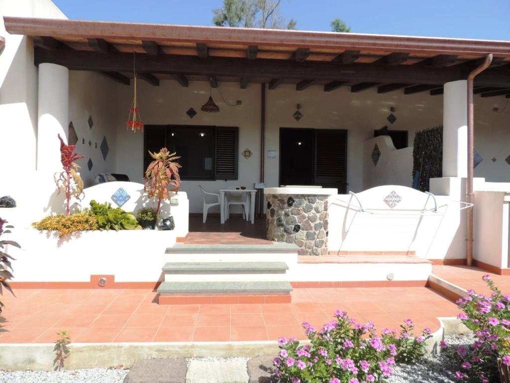 a patio of a house with a wooden pergola at Casa Alicudi in Lipari