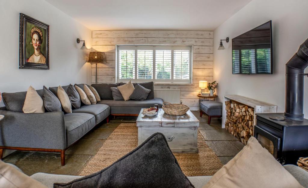 a living room with a couch and a fireplace at Blackshore House in Wenhaston