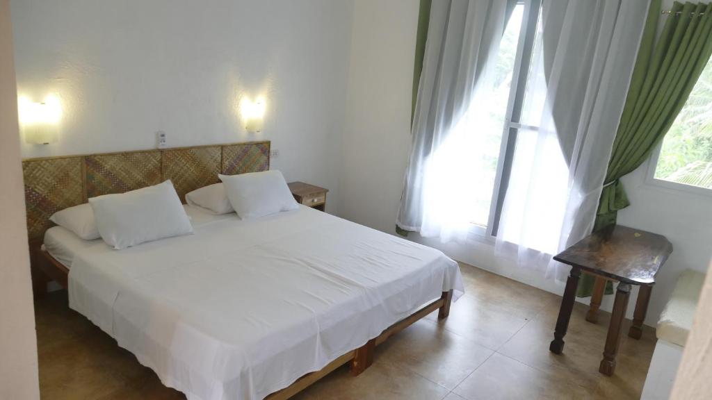 Postel nebo postele na pokoji v ubytování Lanterna Hotel Boracay
