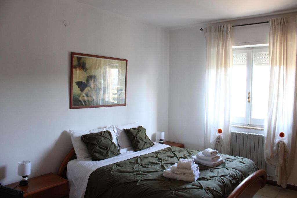a bedroom with a bed with towels on it at Situation House in Catanzaro Lido