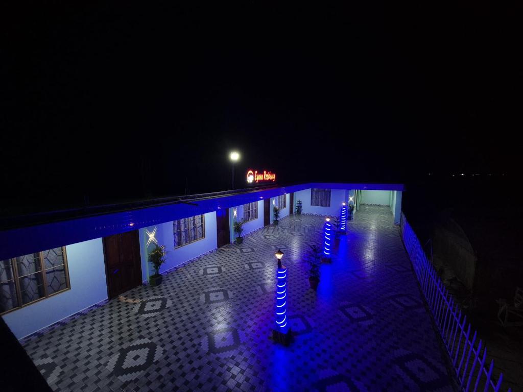 a row of blue lights on a building at night at Eyana Residency in Lāitlyngkot