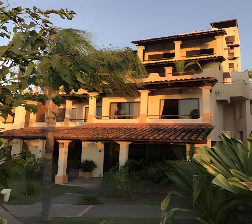 a large building with a tree in front of it at Coco Sunset Hills 52 in Coco