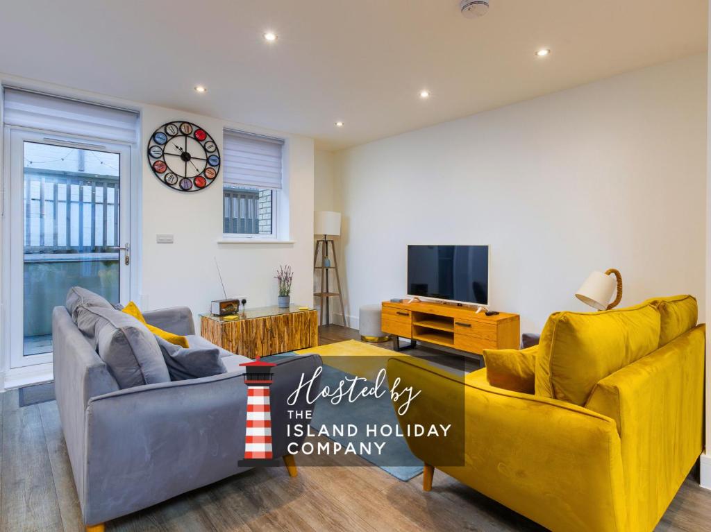 a living room with two couches and a tv at Jollys-Contemporary Beachfront Property, Pet Friendly with optional Hot Tub in Sandown