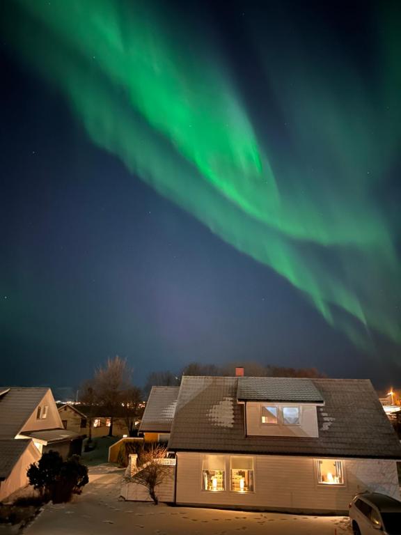 a house with the aurora in the sky at Lofoten - Spacious Room in Vestvågøya