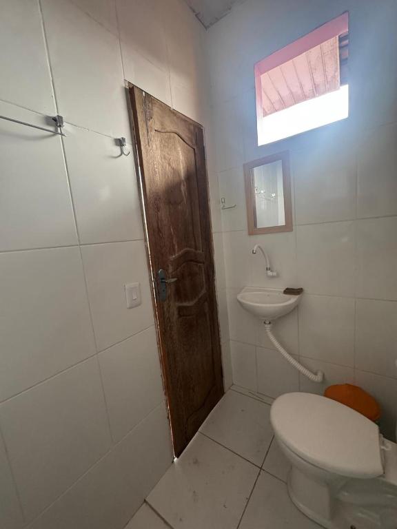 a bathroom with a toilet and a sink at Casa Altos JM in Ananindeua