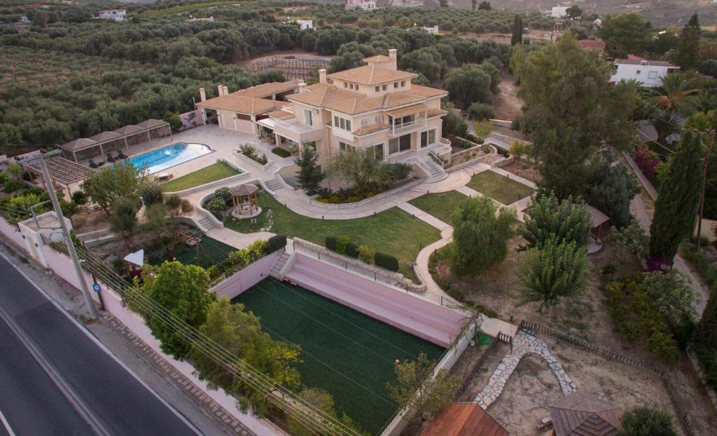 an aerial view of a house with a swimming pool at Villa Metaxas in Káto Kalésia