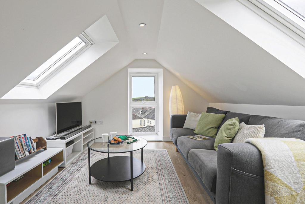 a living room with a couch and a tv at The Loft modern flat in the heart of Wadebridge in Wadebridge