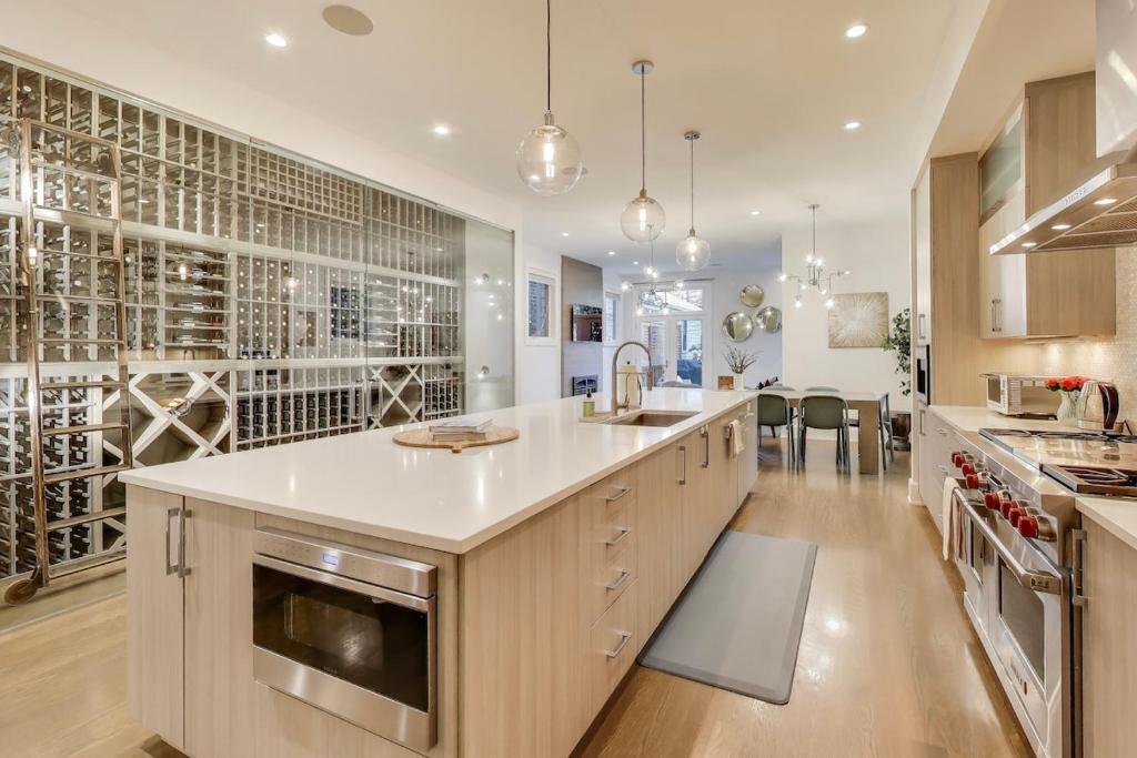 a large kitchen with a large white counter top and cabinets at Hello Again, Chicago! in Chicago