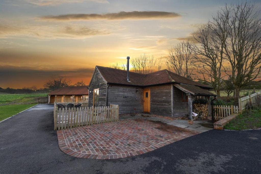 a small house with a fence in front of it at 2 Bed in Tenterden oc-tn606 in Stone