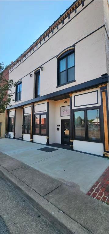 a large white building with windows on a street at The Luxe Building- 2 Bedroom Apartment in Metropolis in Metropolis