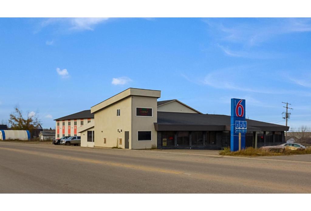 a building on the side of a street with a no parking sign at Motel 6 Kerrobert, SK in Kerrobert