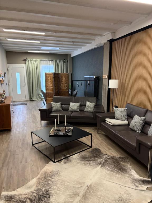 a living room with a couch and a table at Altstadt Quartier Hallenberg - Modernes Ferienappartment in Hallenberg