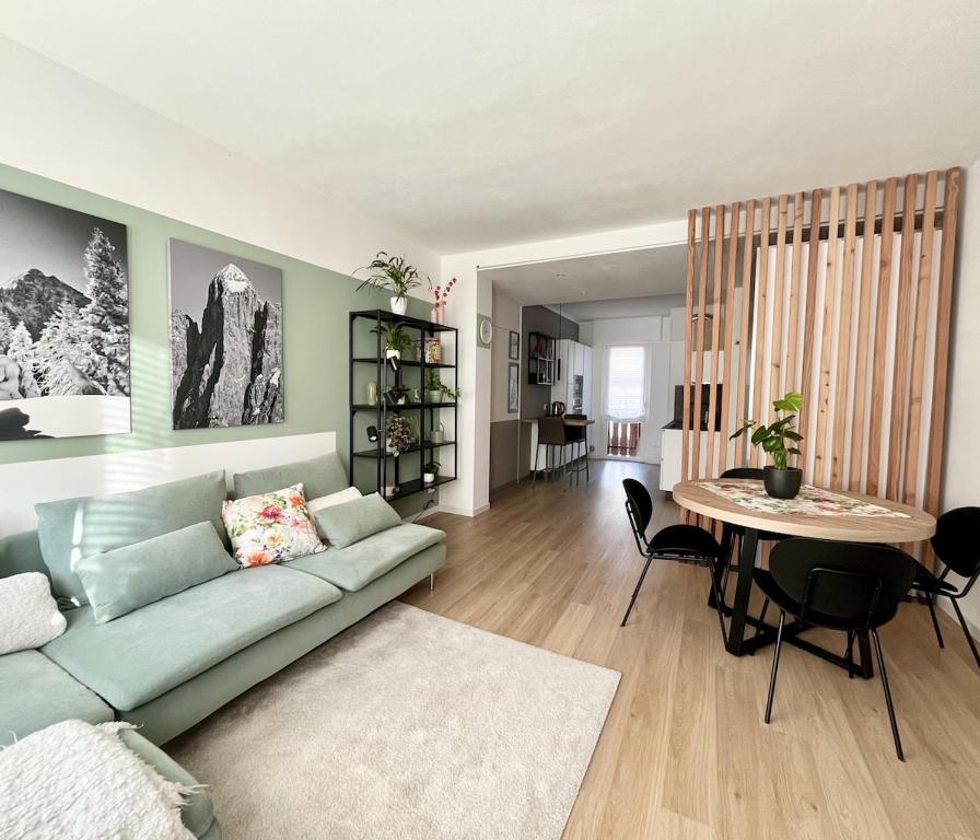 a living room with a couch and a table at The Cozy Peak - 360 Dolomites View in Agordo