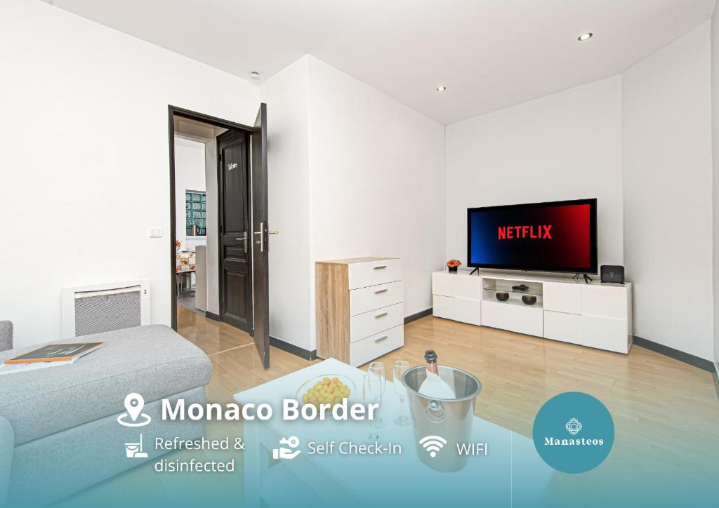 a bedroom with a bed and a tv in a room at Monaco Border - Coquet et Authentique - FM in Beausoleil