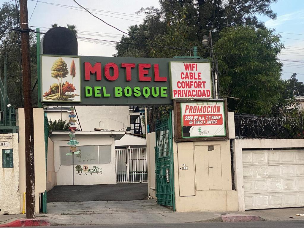 a motel sign on the side of a street at Hotel Del Bosque in Tijuana