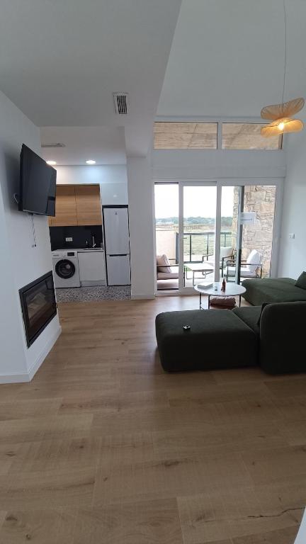 a living room with a couch and a fireplace at Casa Huidobro Valle II in Sardón de los Frailes
