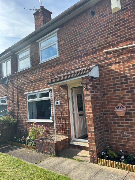 a brick house with a door and a window at Conner house in Middlesbrough