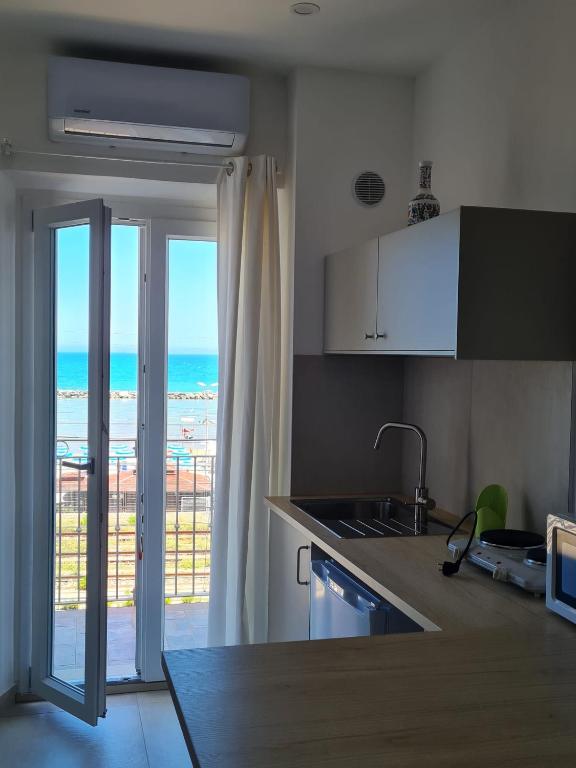 a kitchen with a view of the ocean at Le 2TORRI in Falconara Marittima