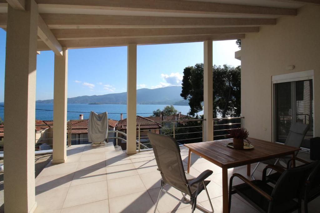 a view from the balcony of a house with a table and chairs at Amanda's House in Poros