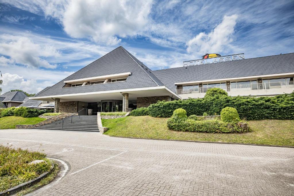 a house with a roof with a driveway at Van der Valk Hotel Assen in Assen