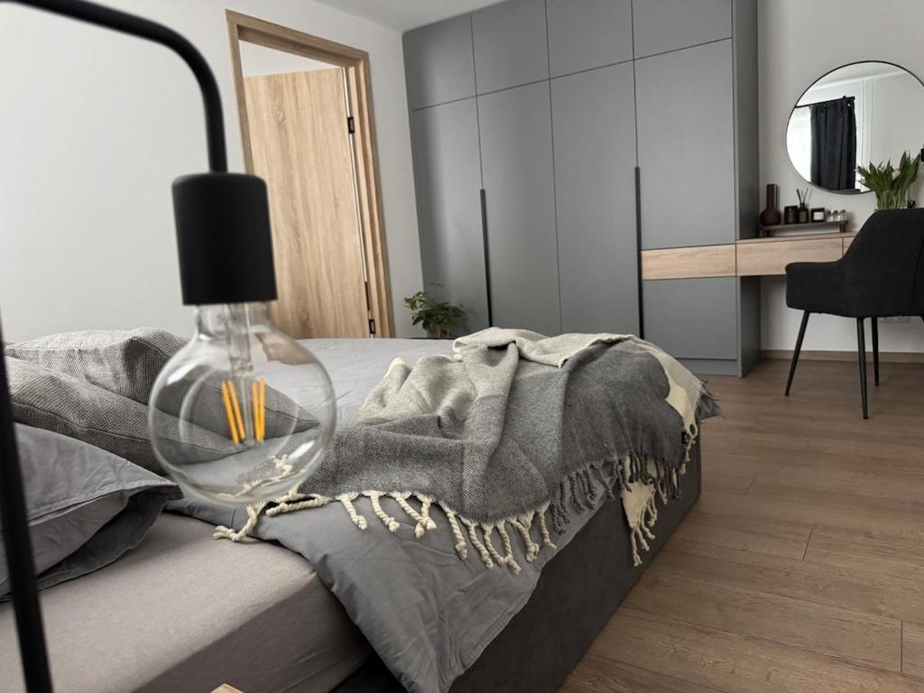a bedroom with a bed with a wine glass on it at Central Apartment in Jelgava