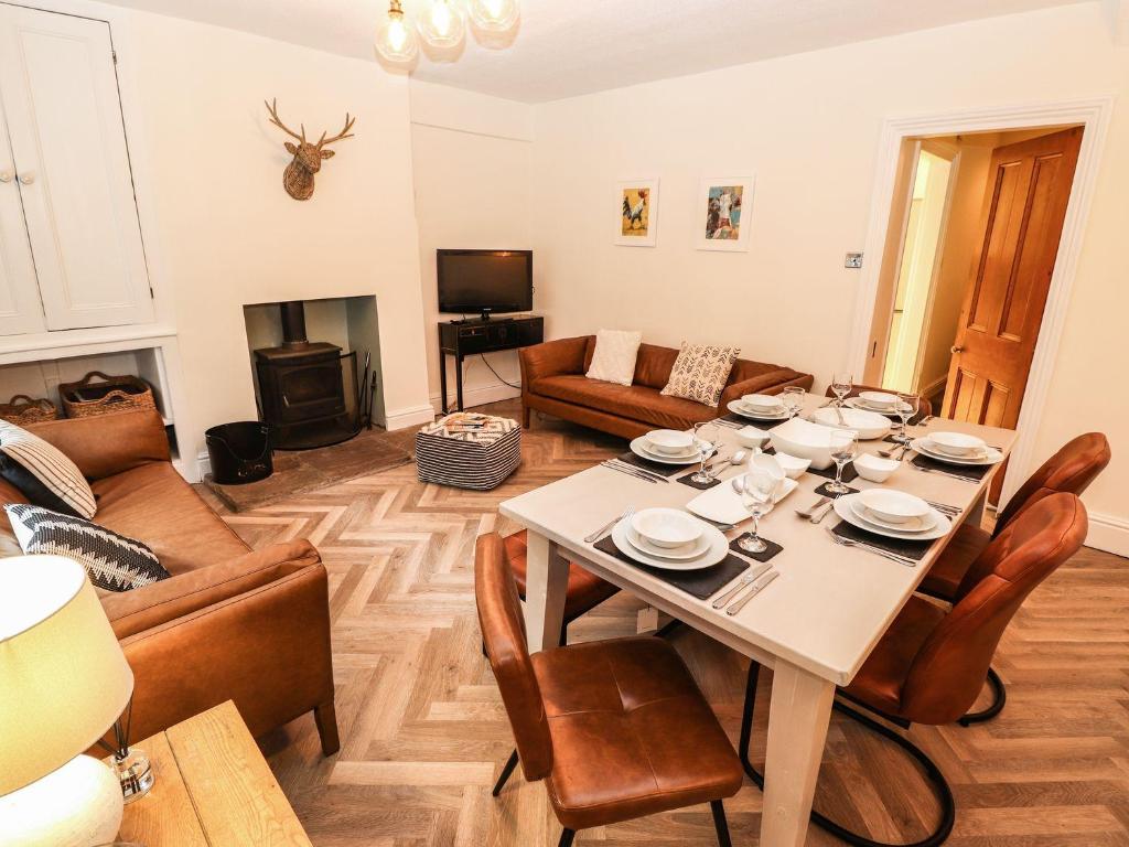 a living room with a table and a couch at Waterhead Cottage in Ambleside