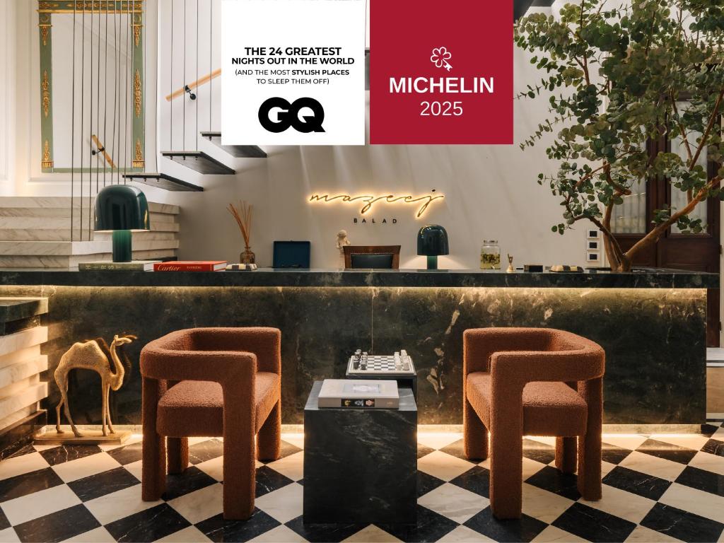 a lobby with two bar stools and a table at Mazeej Balad - Boutique Hotel - Adult Only in Cairo