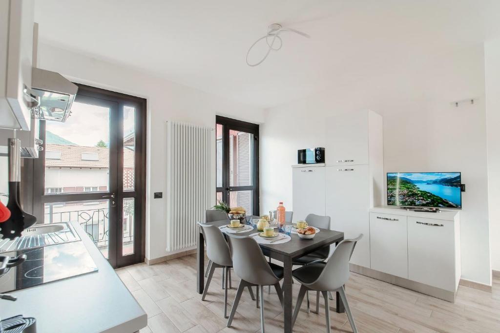 a kitchen and dining room with a table and chairs at Lake Como Retreat Menaggio in Menaggio