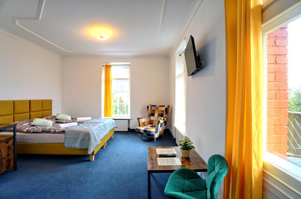 a hotel room with a bed and a couch at Hotel Krasnoludki in Sosnówka