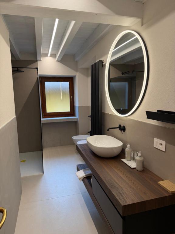 a bathroom with a sink and a mirror at Casa agli Archi in Bardolino