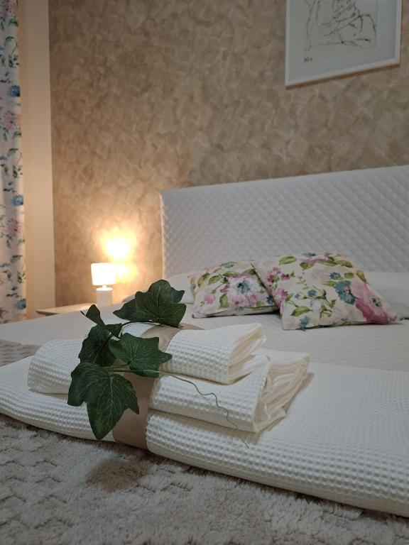 a bed with a pile of folded towels on it at Sciara casa vacanze in Viagrande