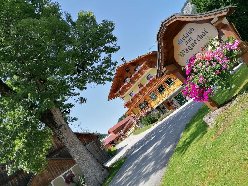 a building with flowers on the side of it at Wagnerhof in Pichl bei Aussee