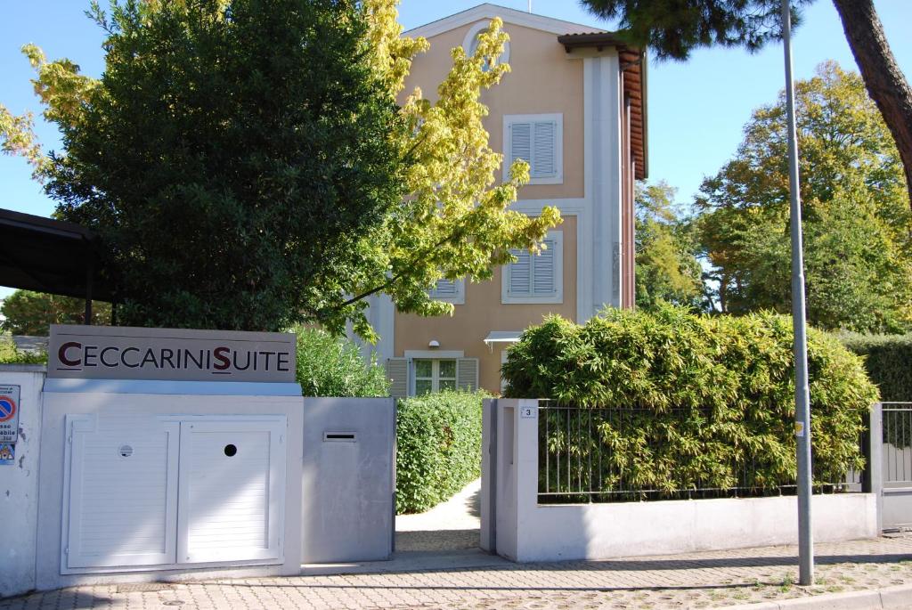 a sign in front of a building with a sign for a gemini suite at Ceccarini Suite in Riccione