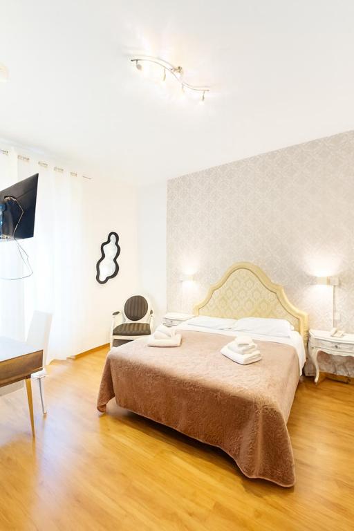 a bedroom with a bed and a table and a chair at Hotel Ariston in Piombino