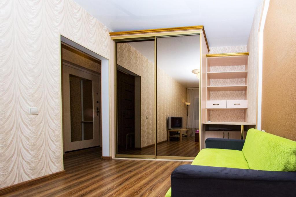 モスクワにあるApartlux Chayanovaのリビングルーム(緑のソファ、鏡付)