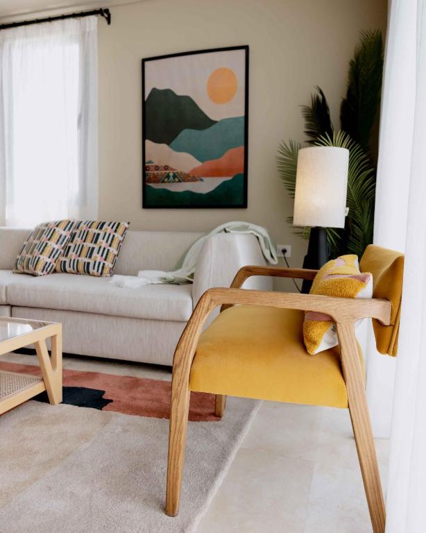a living room with a couch and a chair at Villette Serviced Apartments in Sodic New Cairo in New cairo