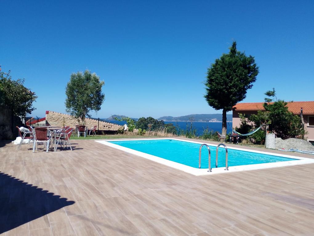 a swimming pool in front of a villa at Eira de Mantoño in Mantoño