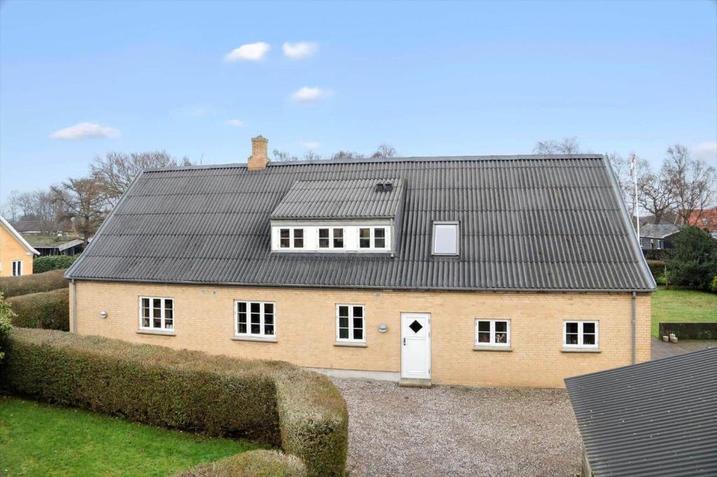 a large brick house with a black roof at 20426-Samso-Nylandsvej-21 in Ballen