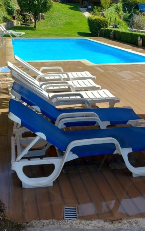 a group of beds sitting next to a swimming pool at Casa Afonso in Ventosa
