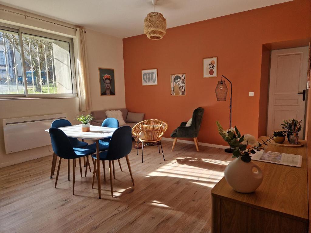 a living room with a table and chairs at Les appartements de Lucie in Eaux-Bonnes