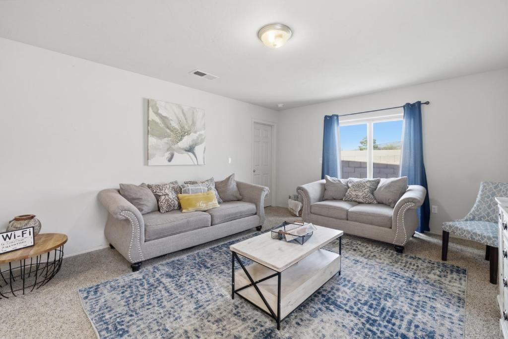 a living room with two couches and a table at The Alturas in Alamogordo