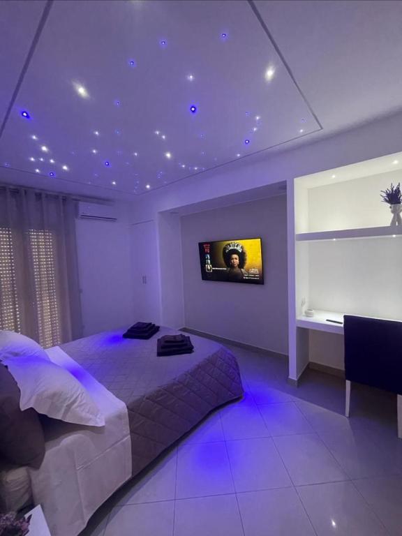 a bedroom with a bed and a tv on the ceiling at Suite Benvenuti al Sud in Crotone