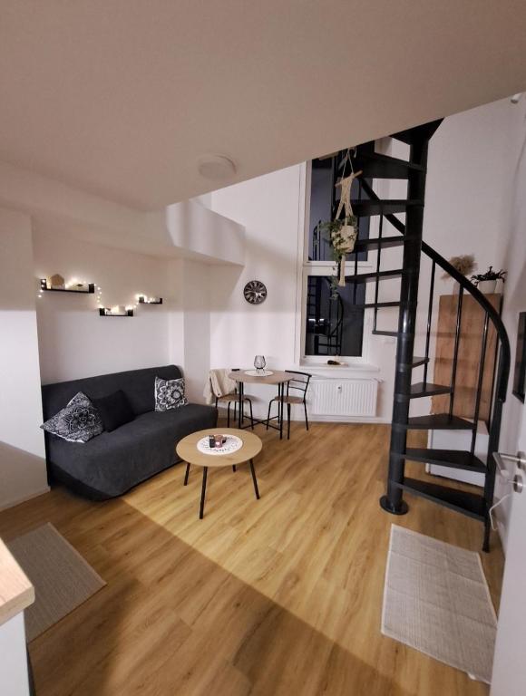 a living room with a couch and a table at ApartmánPohoda in Opava