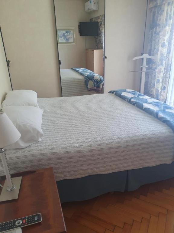 a bedroom with a large bed with a mirror at En lo de dan V in Buenos Aires