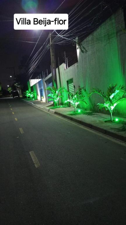 a street with green lights on the side of a building at Villa Beija-flor in Camacari