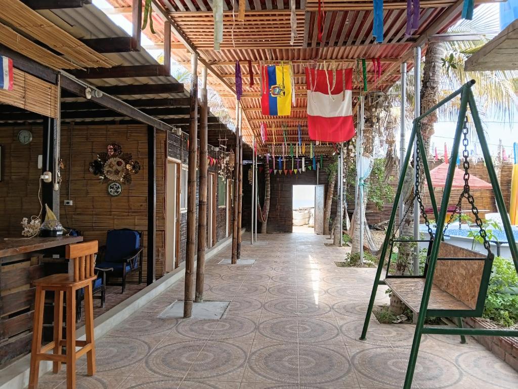 an empty hallway of a house with flags hanging from the ceiling at Arrullos del Mar in Zorritos