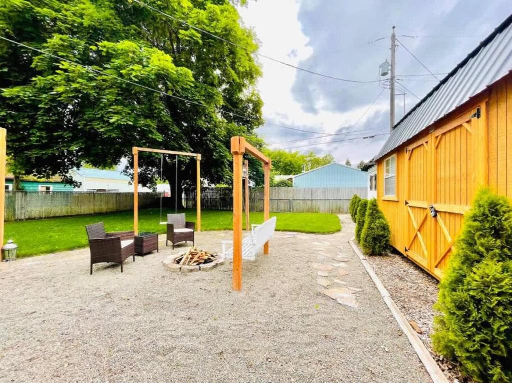 a backyard with a swing set and a playground at Copper Voyage, Fenced Backyard in Coeur d'Alene