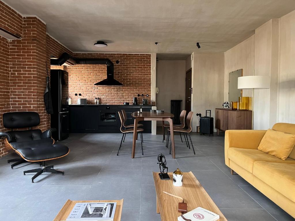 a living room with a couch and a table at hellofrom Tobacco Warehouse in Kavála